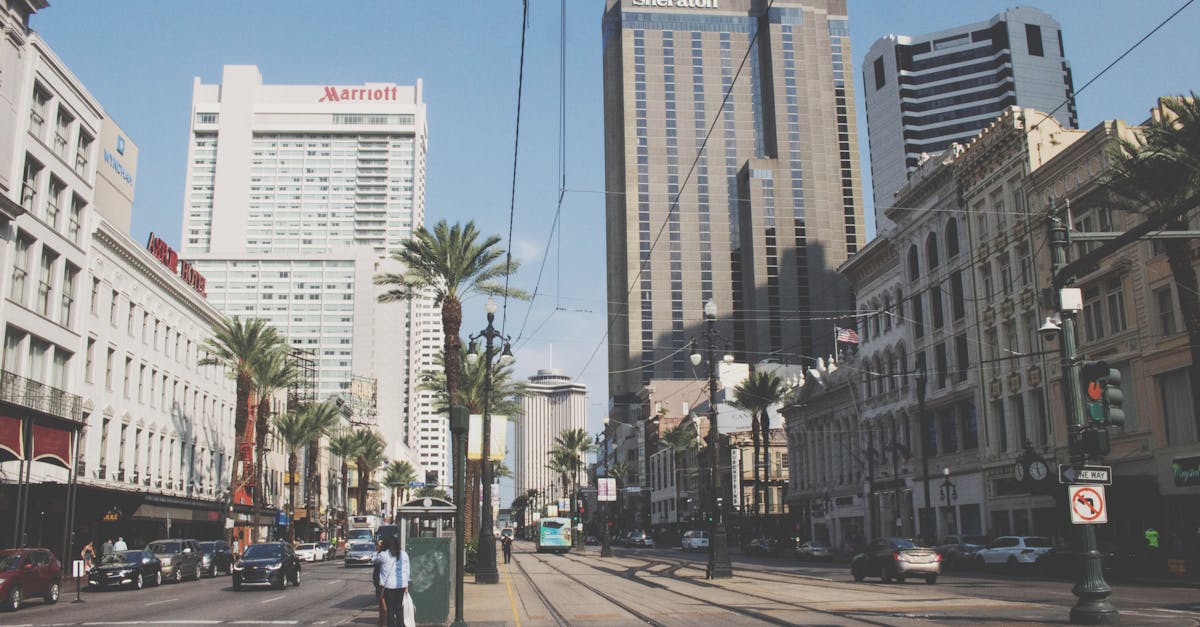 Bustling street view of downtown New Orleans, showcasing high-rise buildings and city life.
