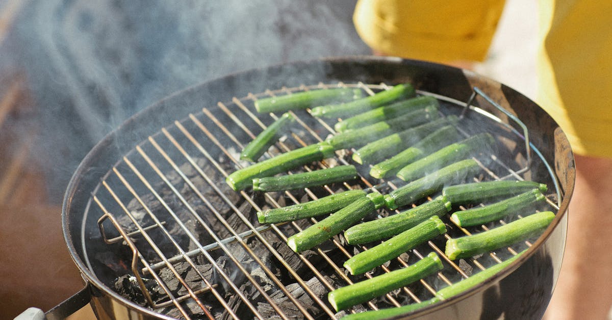 Close-up of a barbecue grill with fresh vegetables smoking outdoors.