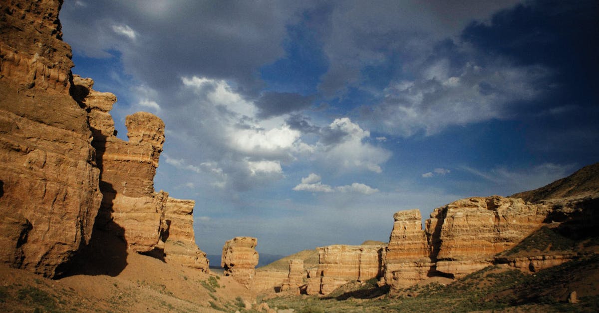 Breathtaking view of a canyon under a dramatic sky with rock formations.