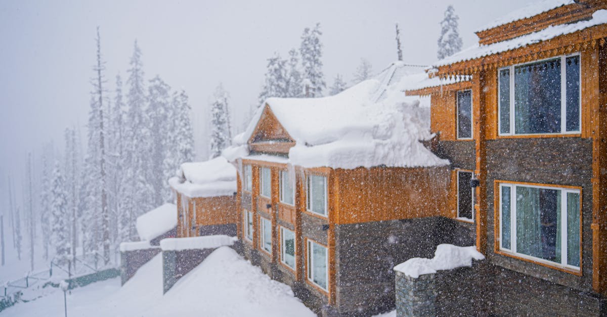 Charming wooden houses blanketed with snow amidst a serene winter landscape.