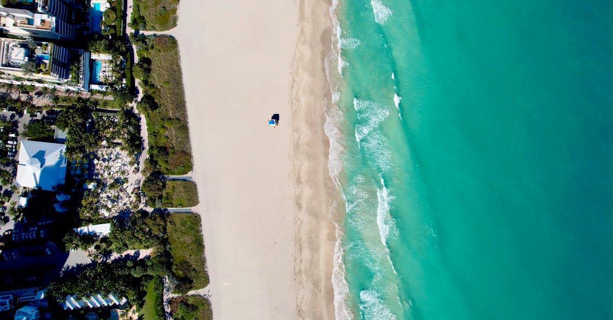 Stunning aerial view of Miami Beach's coastline, showcasing turquoise waters and sandy shorelines.