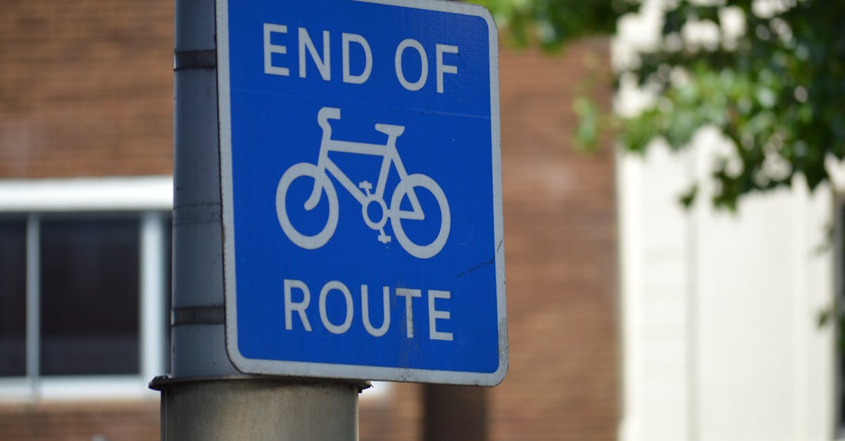 Close-up of a blue bike 'End of Route' sign mounted on a pole, suggesting route termination.