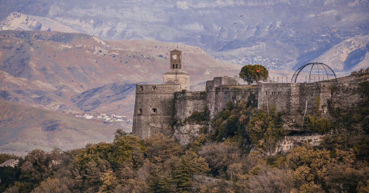 Gjirokaster Fortress stands majestically amidst the Albanian mountains, showcasing rich history and stunning architecture.