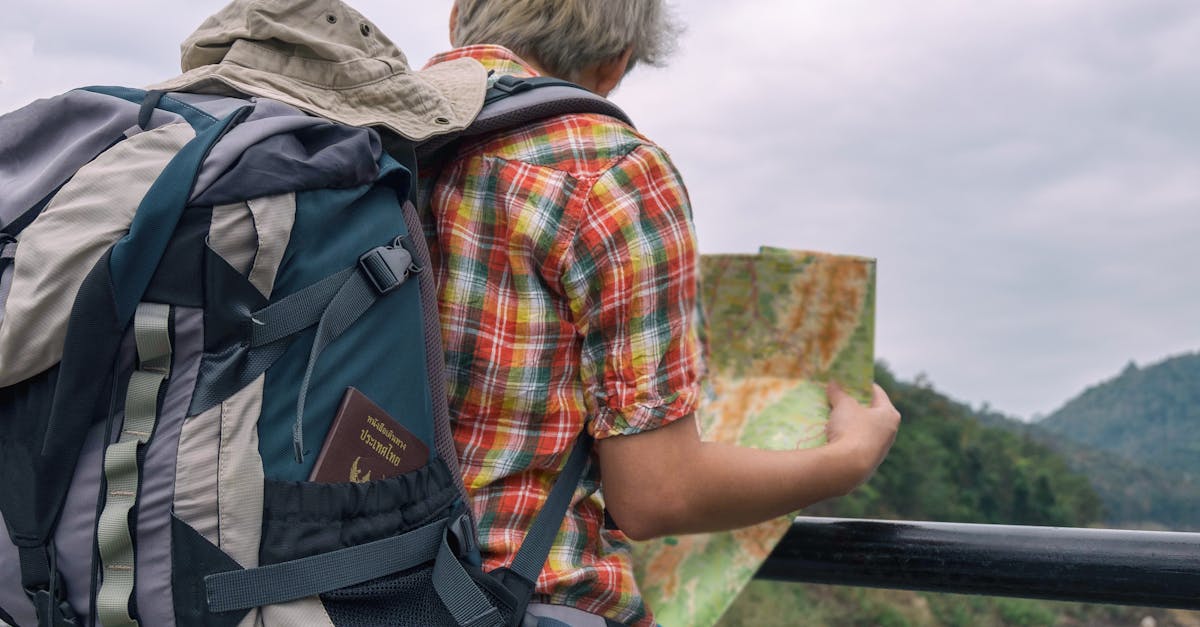 A backpacker examining a map against a scenic outdoor landscape. Adventure awaits.