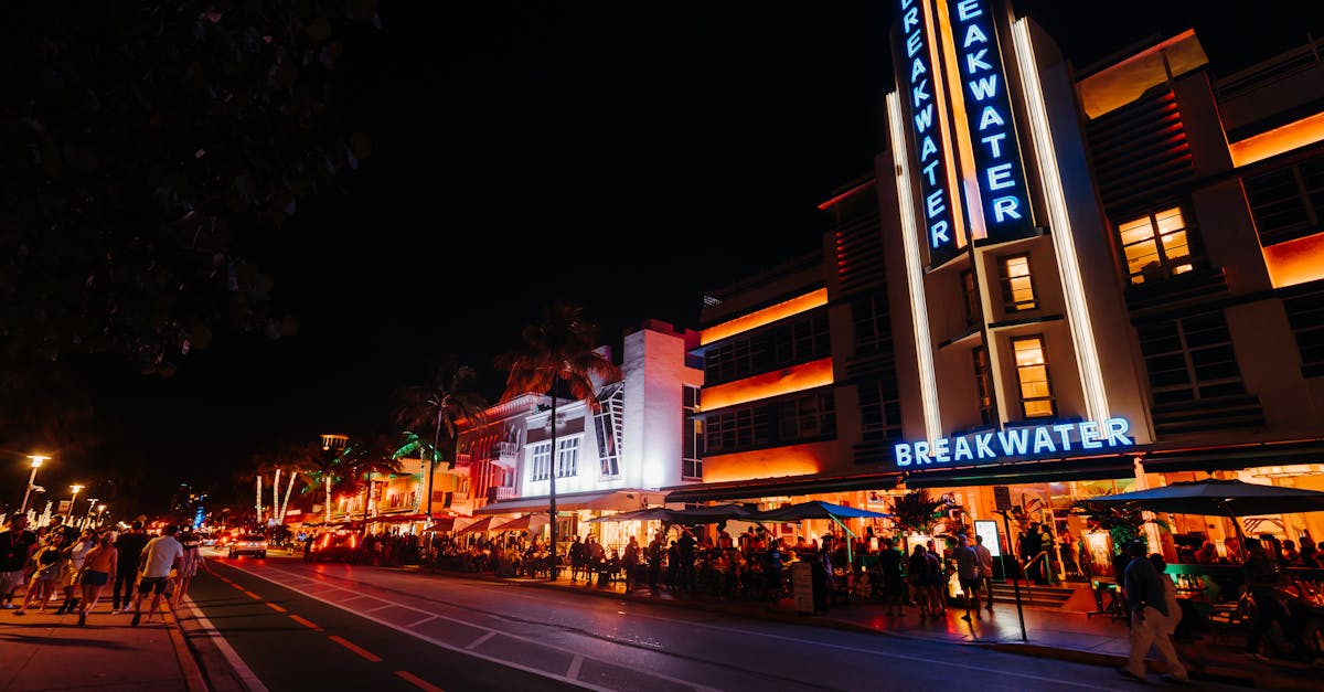 Vibrant nightlife scene in Miami's iconic Art Deco district with neon lights and crowds.
