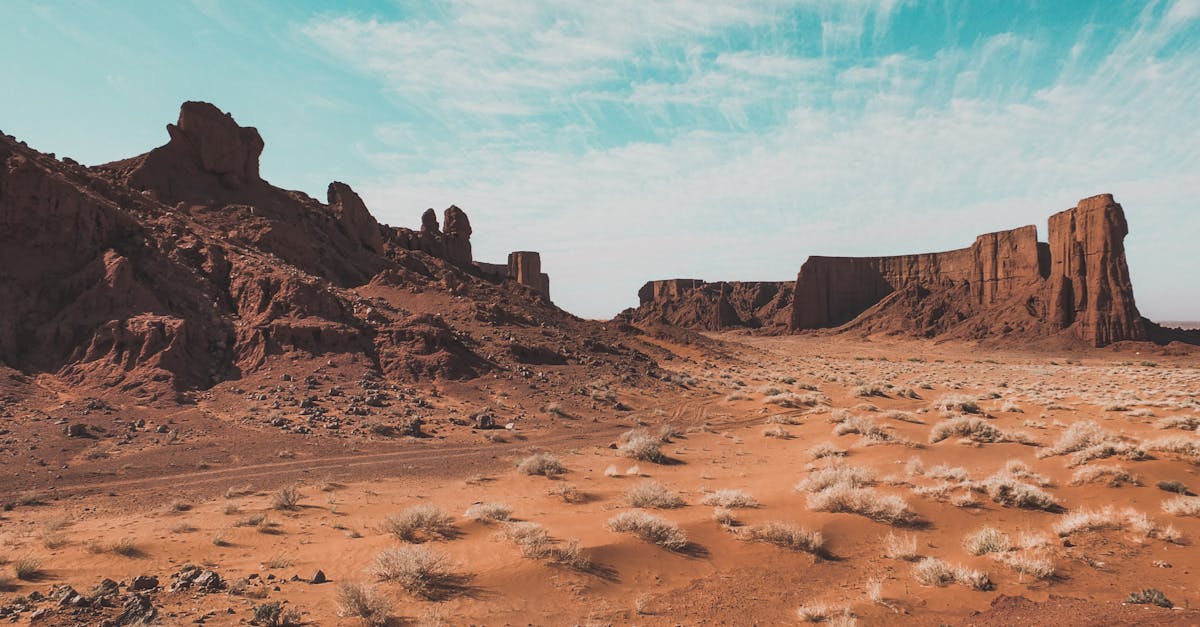 Explore a breathtaking Algerian desert with dramatic rock formations and clear blue skies.