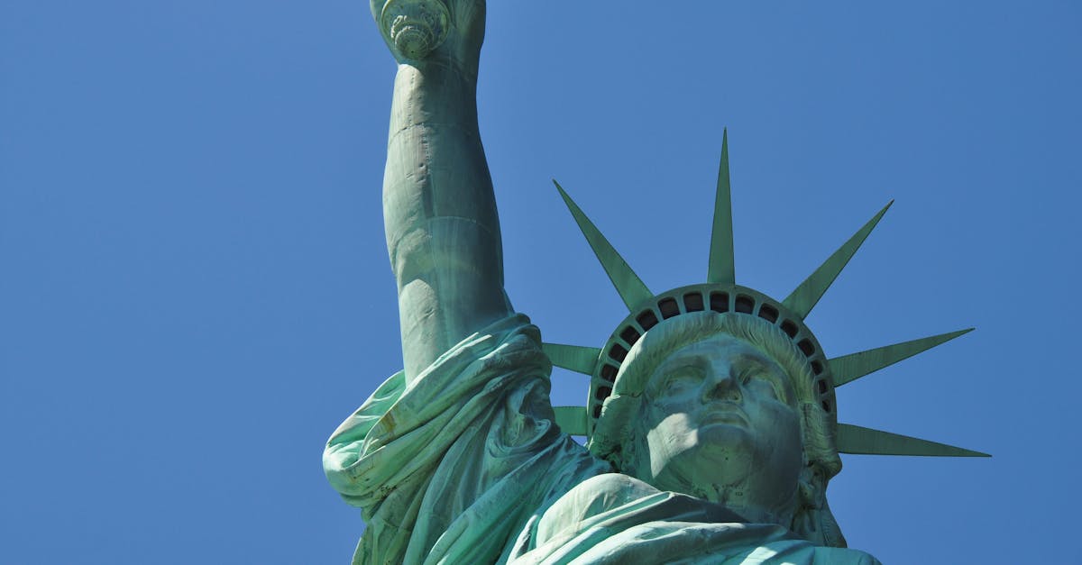 Close-up of the Statue of Liberty against a clear blue sky in New York City, representing freedom.
