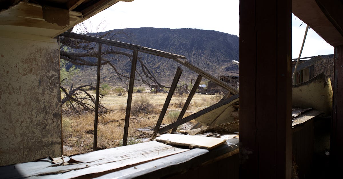 Explore the decaying remnants of an abandoned building in the Arizona desert with scenic mountain views.