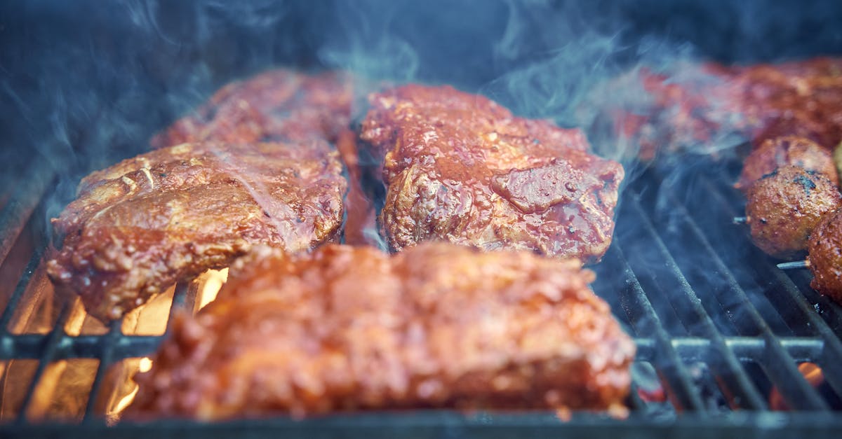 Tasty barbecue ribs sizzling on the grill, perfect for summer gatherings.