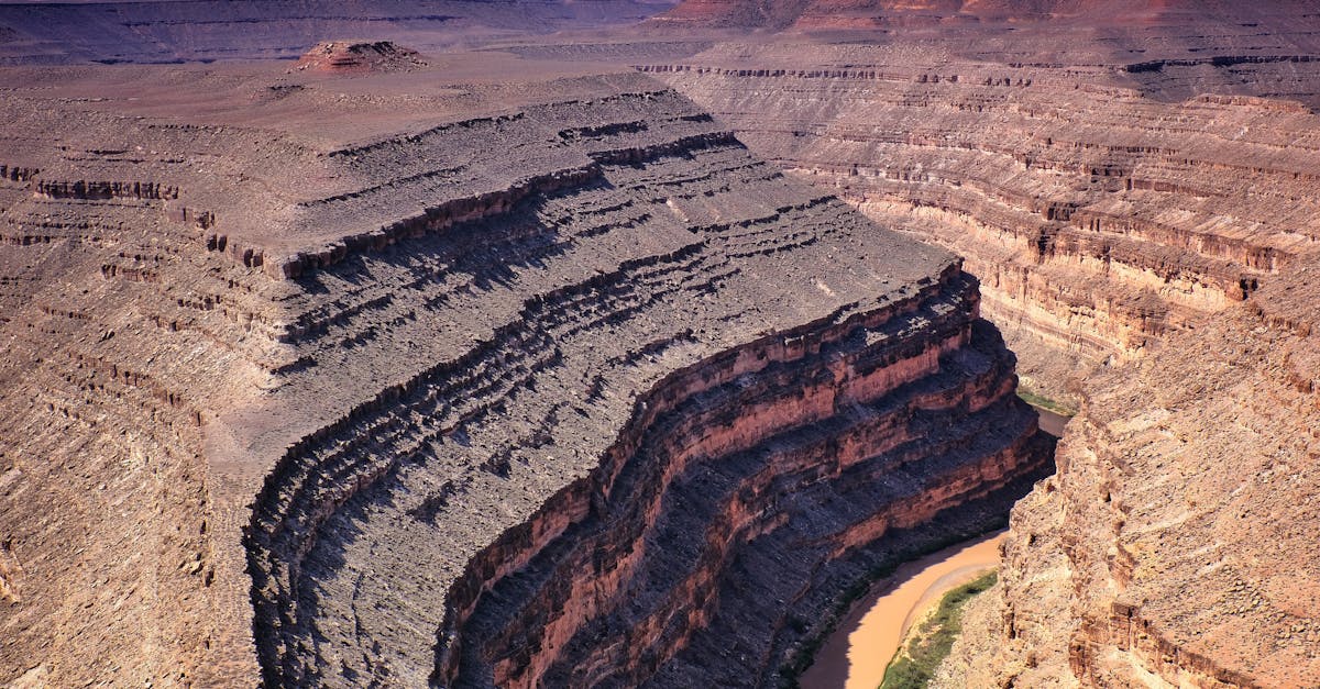 Drone capture of dramatic rock formations at Gooseneck Canyon with a winding river.