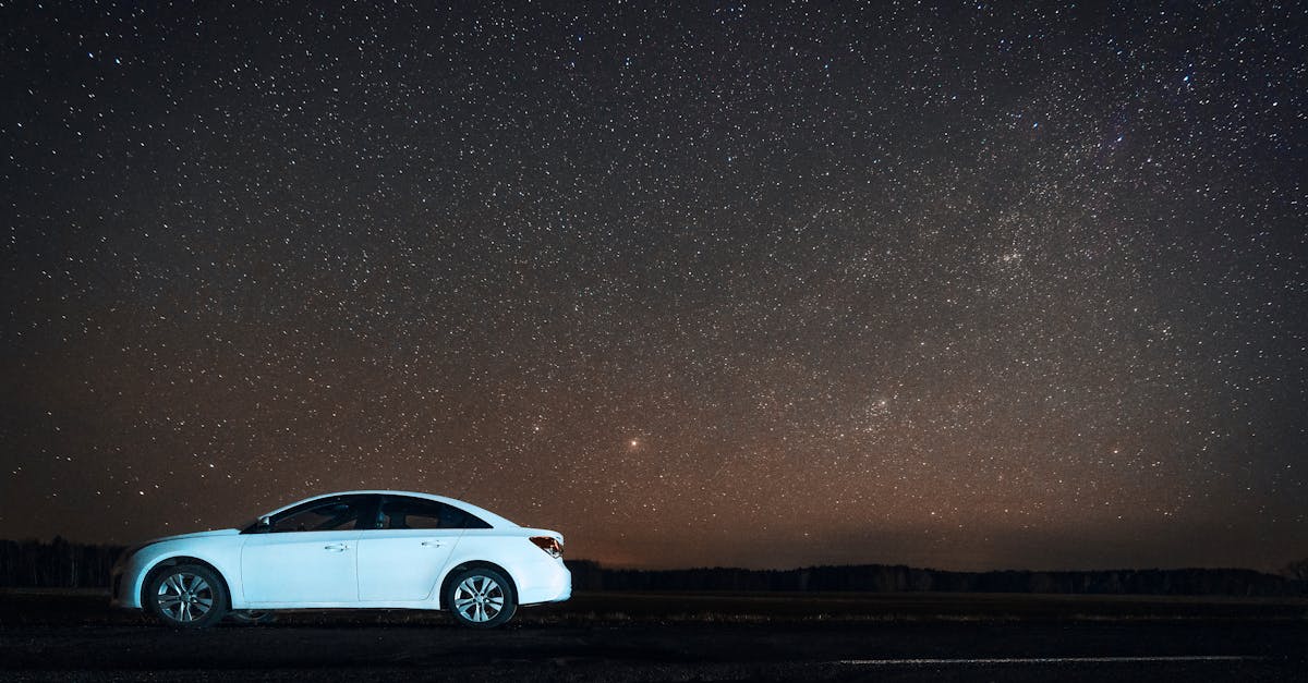 White car parked under a stunning starry sky in Sosenka, Belarus, creating a mesmerizing night view.