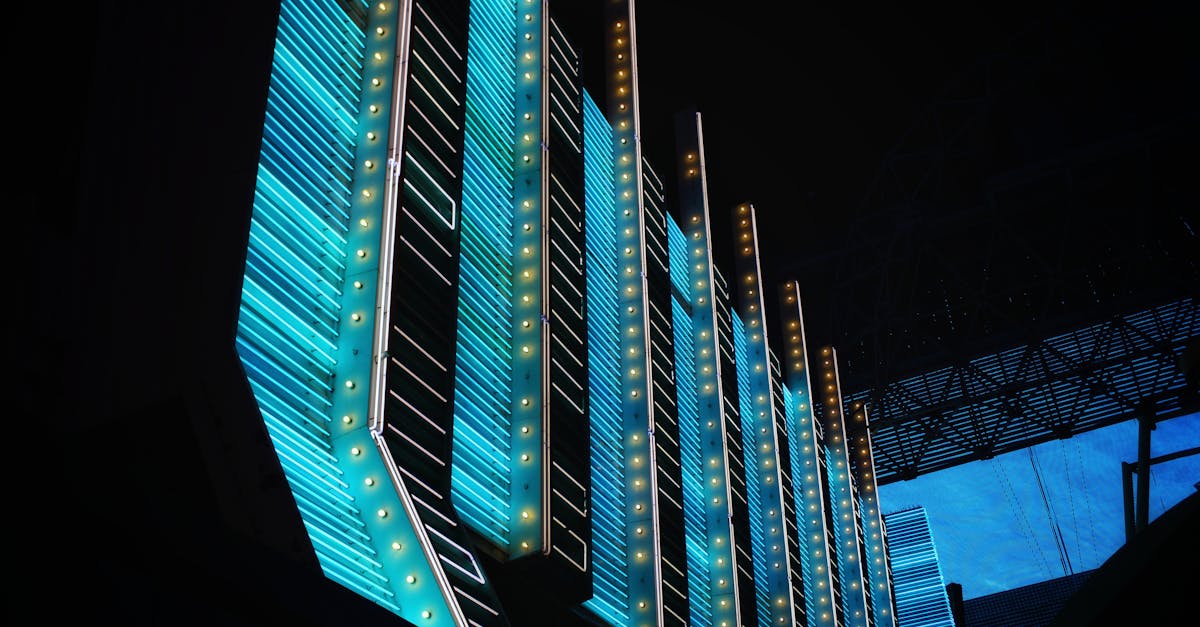 Vibrant neon lights illuminate modern architecture in the heart of Las Vegas at night.