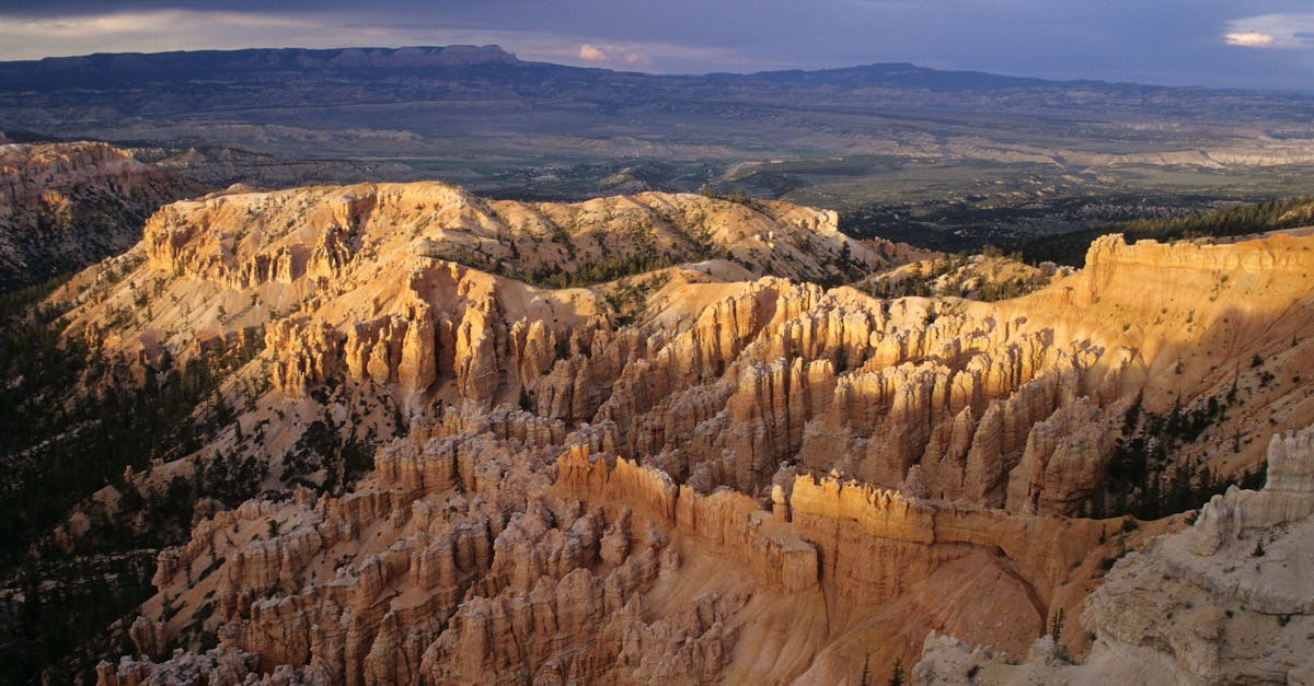 Stunning view of Bryce Canyon with dramatic lighting and geological formations under a dark sky.