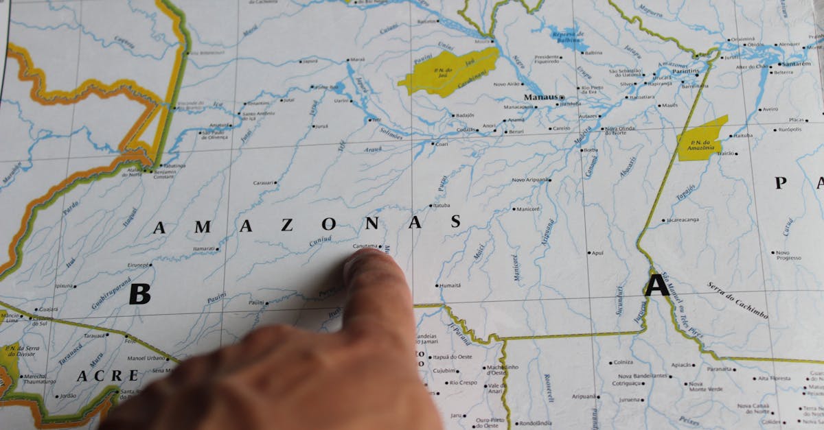 Photo of a hand pointing at Amazonas on a detailed map of Brazil.