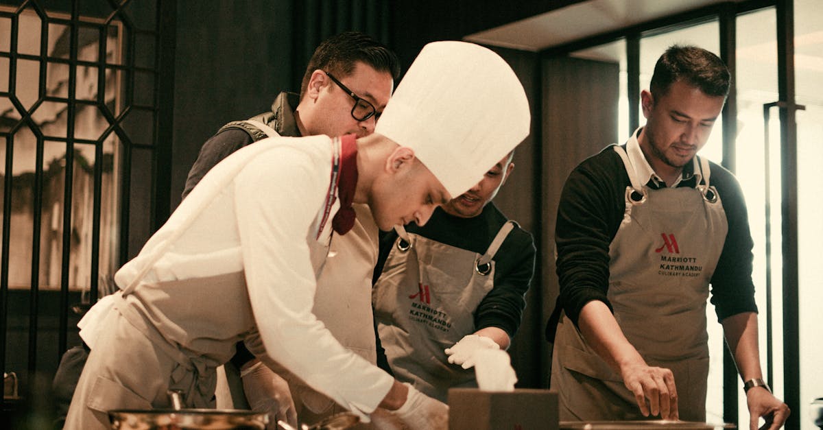Team of chefs working together in a modern restaurant kitchen, preparing gourmet dishes with precision and skill.