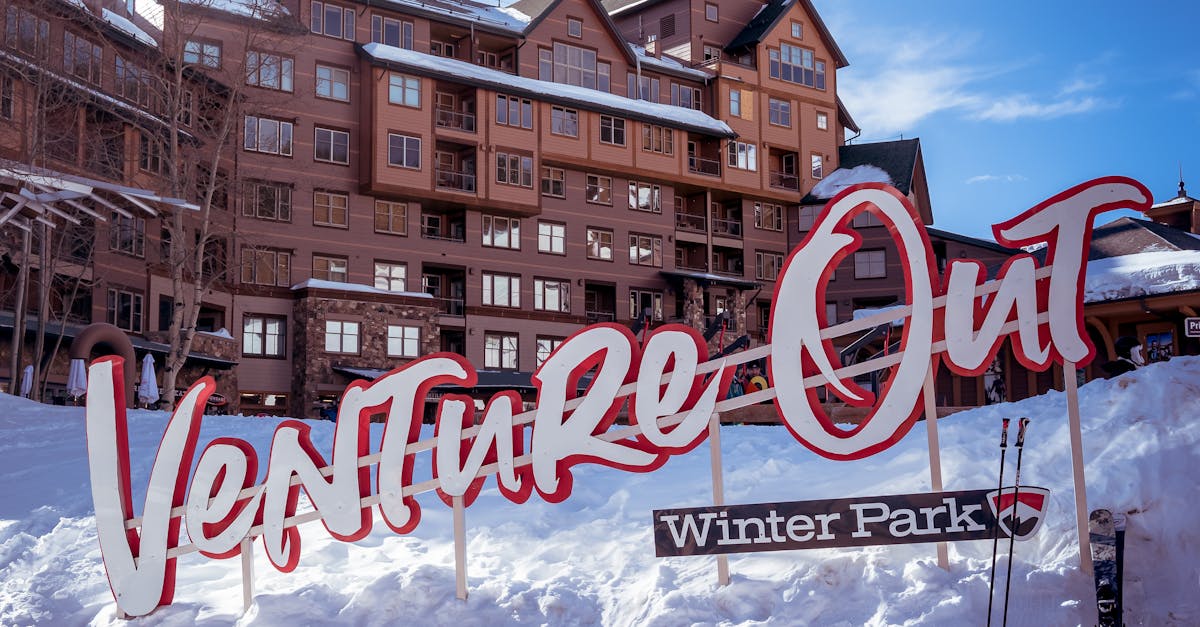 Winter Park ski resort with "Venture Out" sign, perfect winter vacation spot.