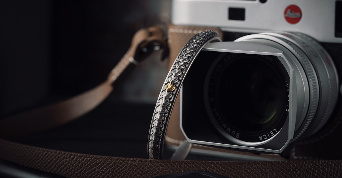 Elegant camera setup with handmade strap and lens cap, perfect for photography enthusiasts.