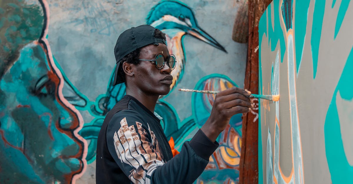 A man painting a vibrant street art mural in Nairobi, Kenya.