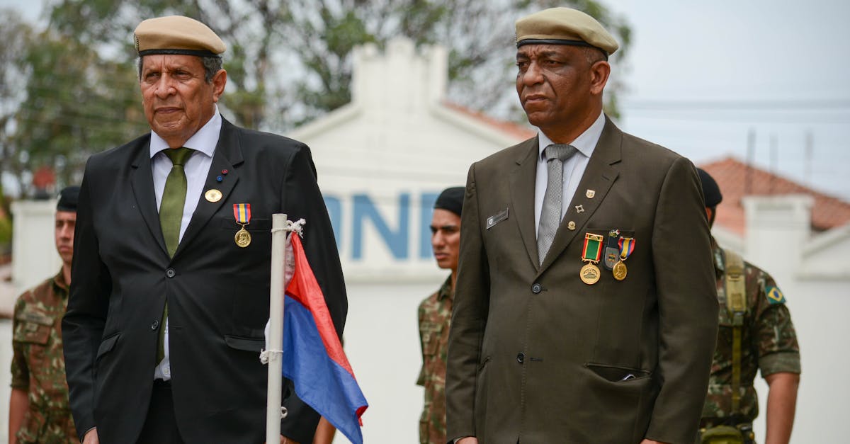 Veterans awarded for service stand solemnly in a military ceremony outdoors.