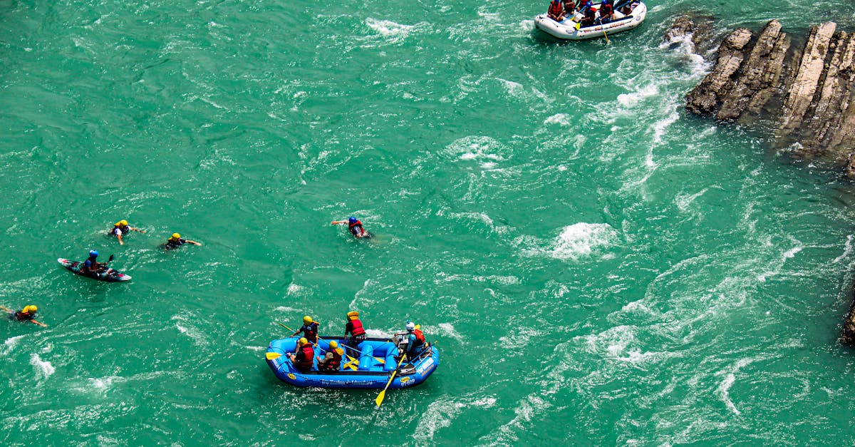 Groups enjoying an exhilarating river rafting and swimming adventure in turquoise waters.