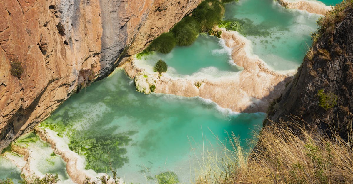 A stunning view of natural lagoons surrounded by rocky cliffs in Ayacucho, Peru.