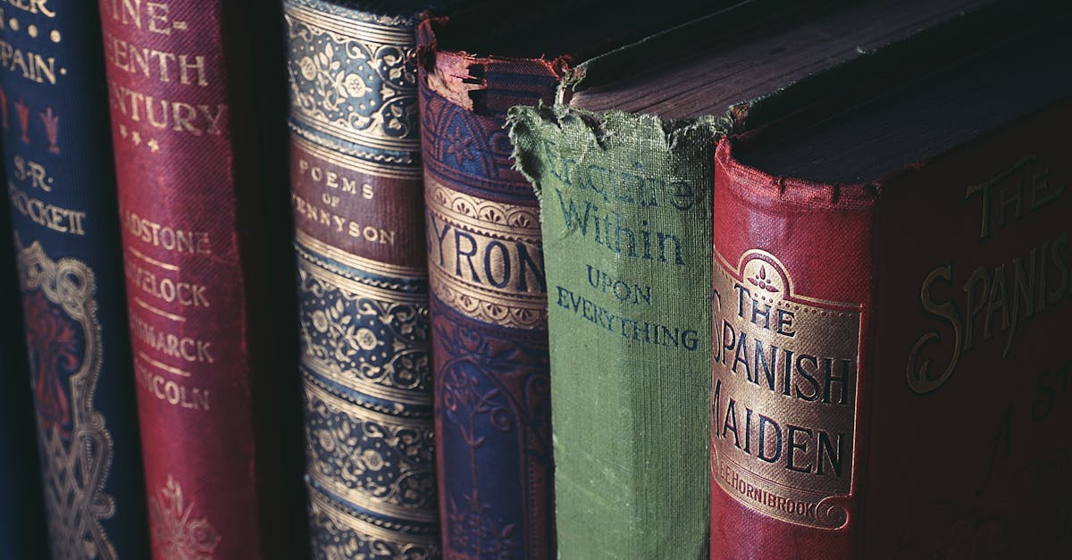 Close-up of vintage hardcover books showcasing ornate book jackets and titles.