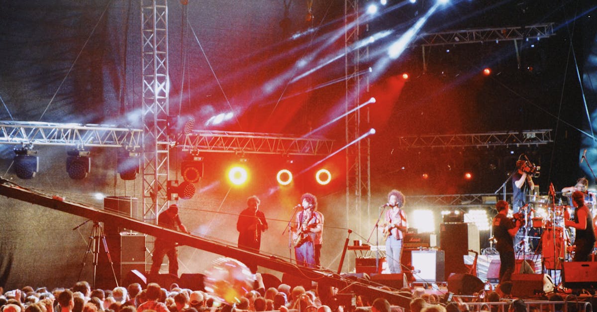 Energetic live concert at night in Almaty with vibrant lights and performing musicians on stage.