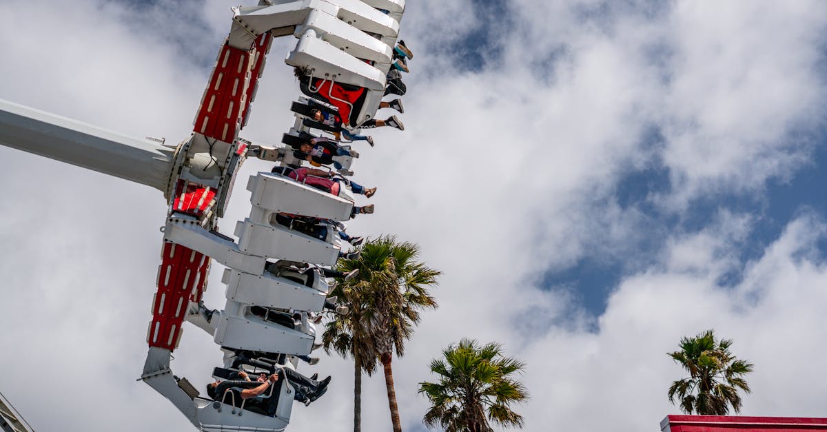 Exciting view of a carnival ride with people enjoying under a bright blue sky.