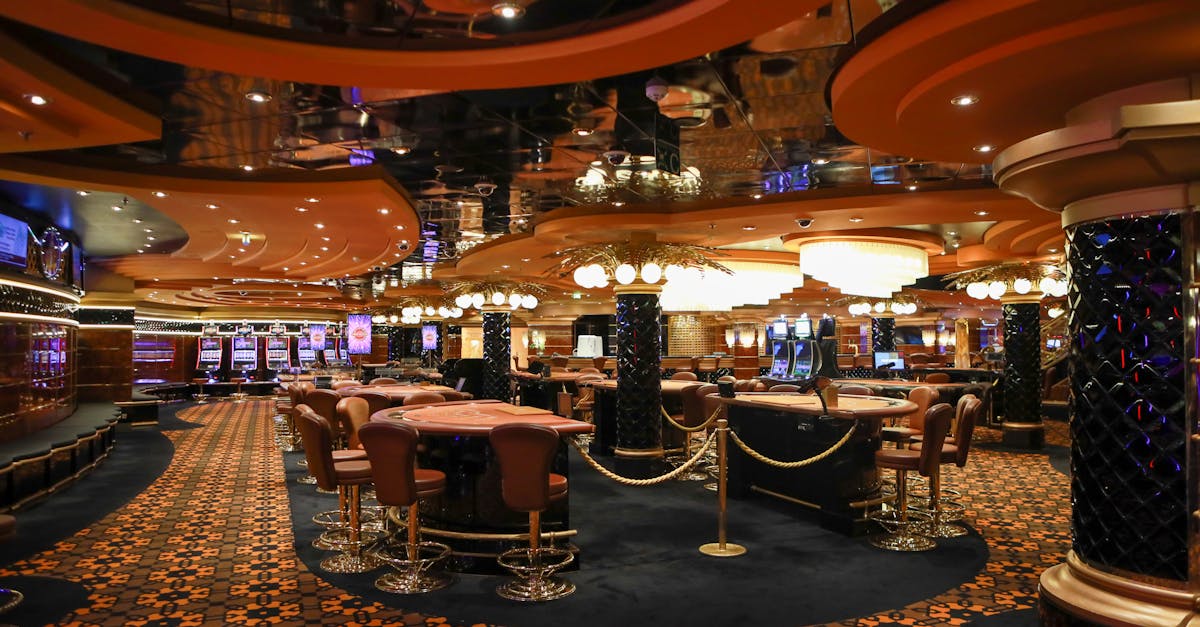 Lavish casino interior featuring slot machines and elegant furnishings under soft lighting.