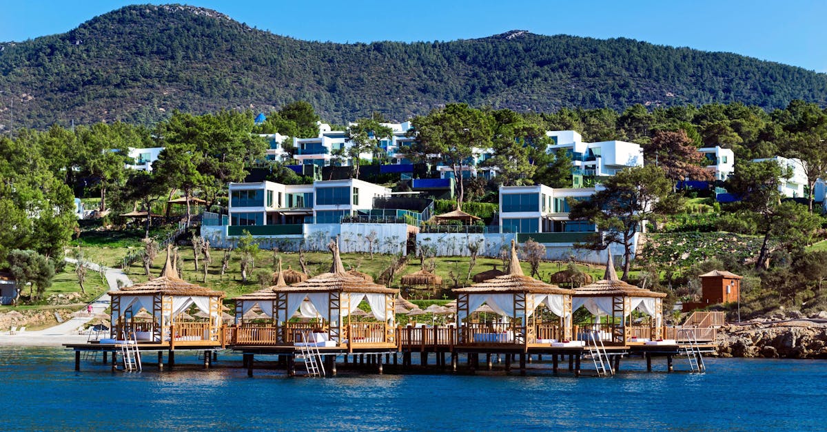 Beautiful seaside resort featuring cabanas and villas by the lush hillside.