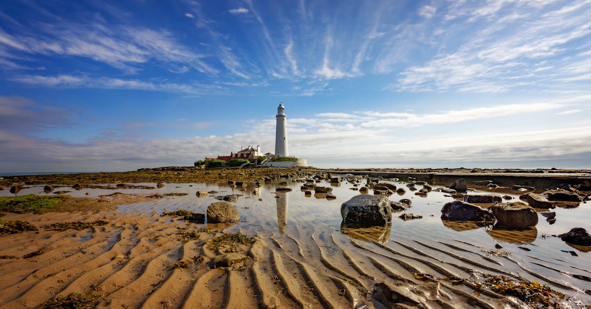 Beautiful capture of St Mary's Lighthouse with reflections in tidal pools.