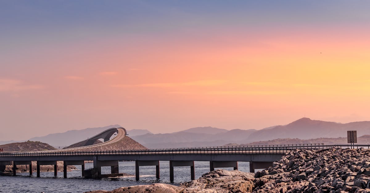 A breathtaking view of the Atlantic Road in Norway with a stunning sunrise backdrop.