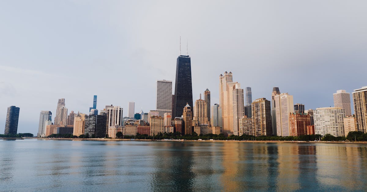 Stunning view of Chicago's skyline with calm waterfront reflections under a clear sky.