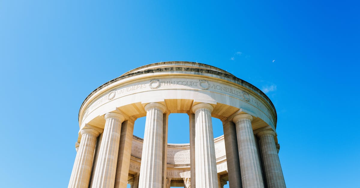 Elegant neoclassical structure with columns under a clear blue sky, perfect for architectural exploration.