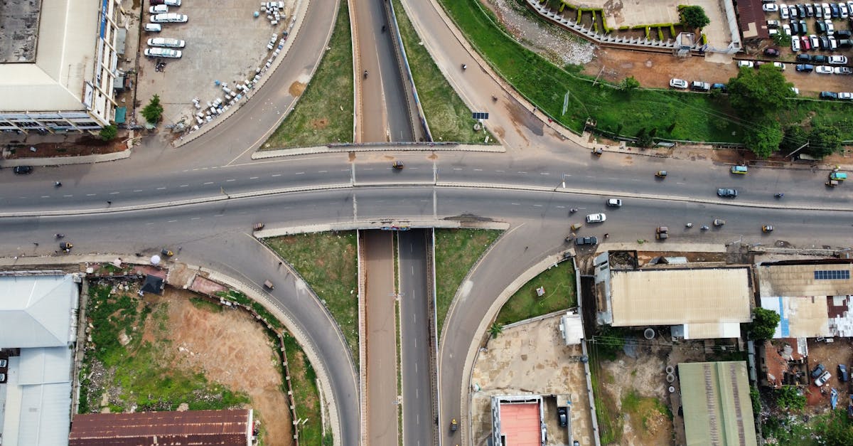 Aerial shot of a city intersection with roads and buildings, showcasing urban planning.