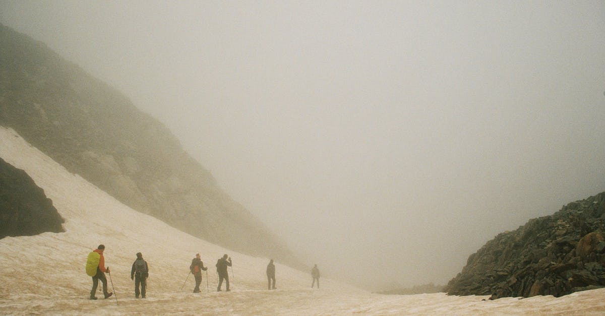 Adventurers navigate a foggy mountain landscape in Spain, capturing a serene winter trek.