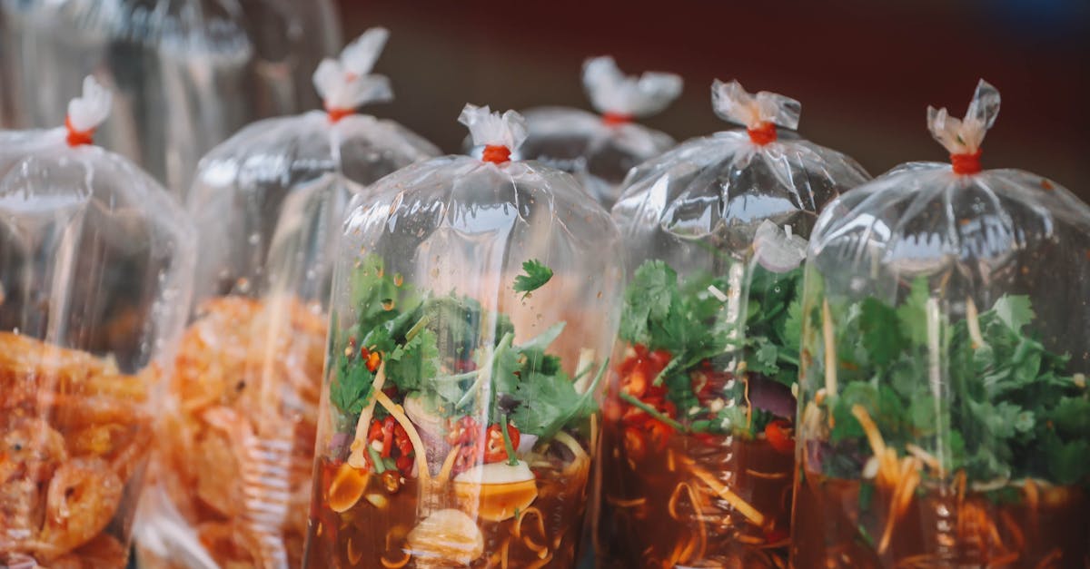 Colorful Thai street food neatly packaged in transparent bags at a Bangkok market.