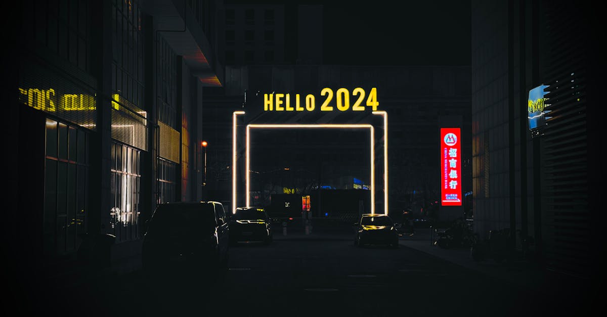 Urban night scene features an illuminated 'Hello 2024' sign in a bustling city alleyway.