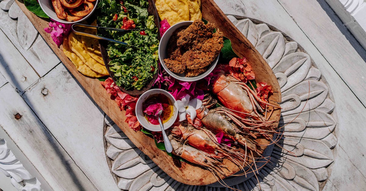 A vibrant Zanzibar seafood platter with prawns and sides on a decorative table.