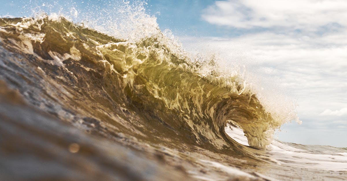 Powerful ocean wave crashing under clear sky at Arenas Verdes, Argentina.