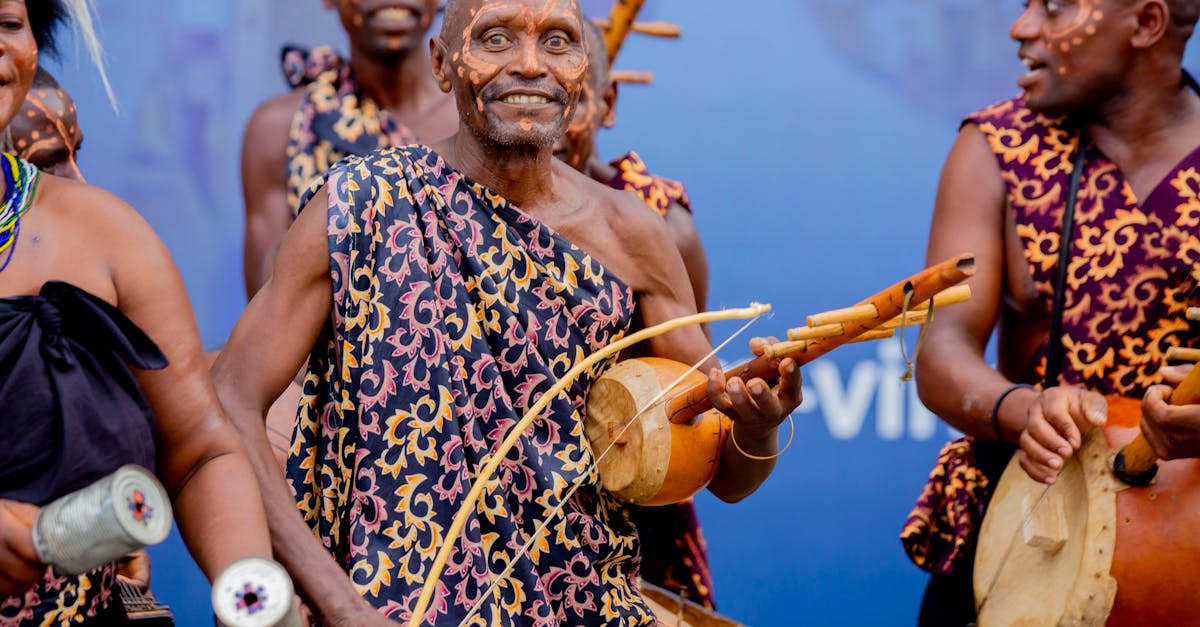 Joyful musicians performing African music with traditional instruments and attire.