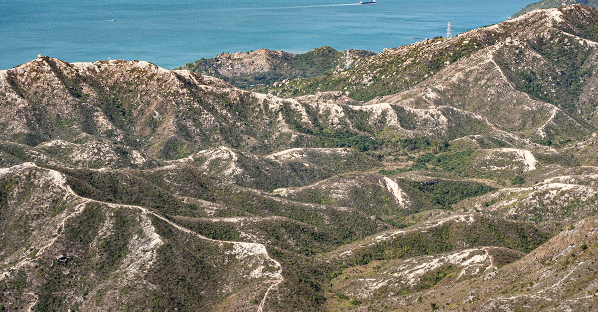 Scenic aerial view of Hong Kong’s rugged mountain terrain leading to the coastal waters.