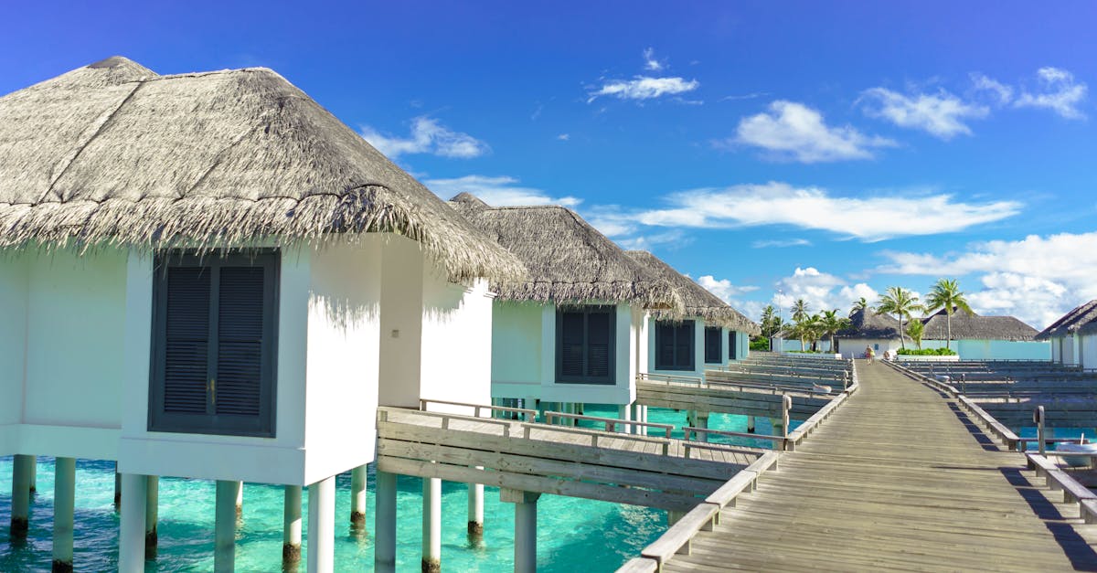 Scenic view of luxurious overwater bungalows on a sunny tropical day, ideal for travel and relaxation.