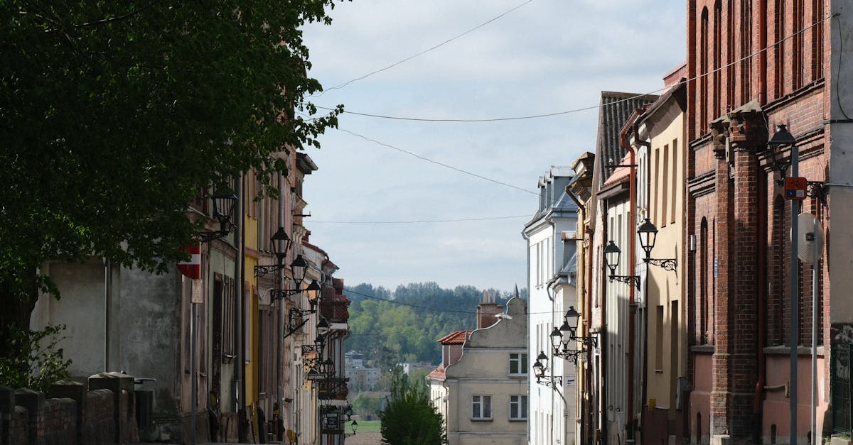 Cobblestone street flanked by historic European buildings, showcasing quaint charm and vintage architecture.