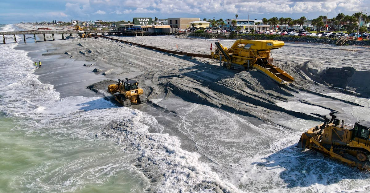 Aerial view of beach construction with machinery at Flagler Beach, FL.
