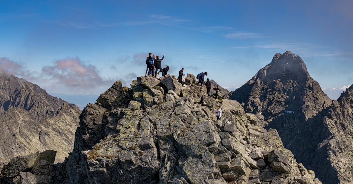 Group of hikers enjoy breathtaking views from Rysy mountain summit, Tatras.