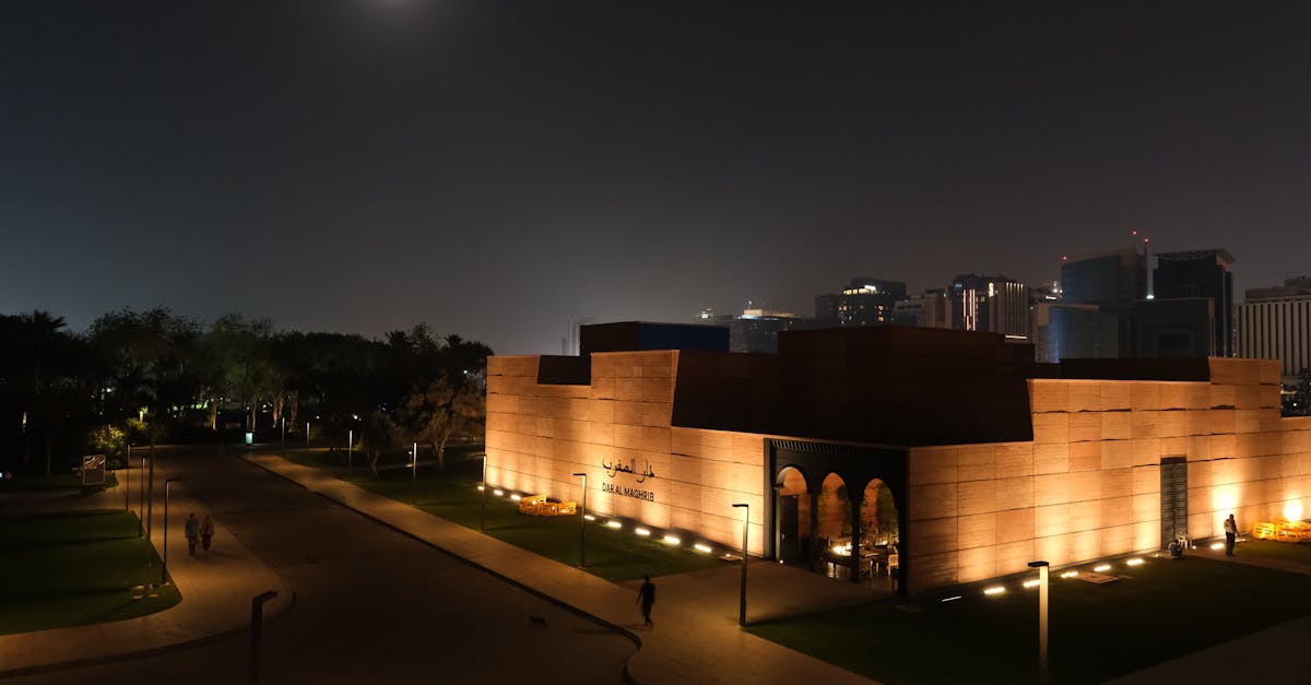 Stunning night view of Doha's Fire Station building illuminated under moonlight with a city backdrop.