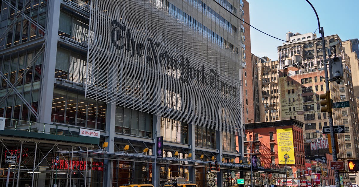 The iconic New York Times building with yellow taxis in bustling Manhattan.