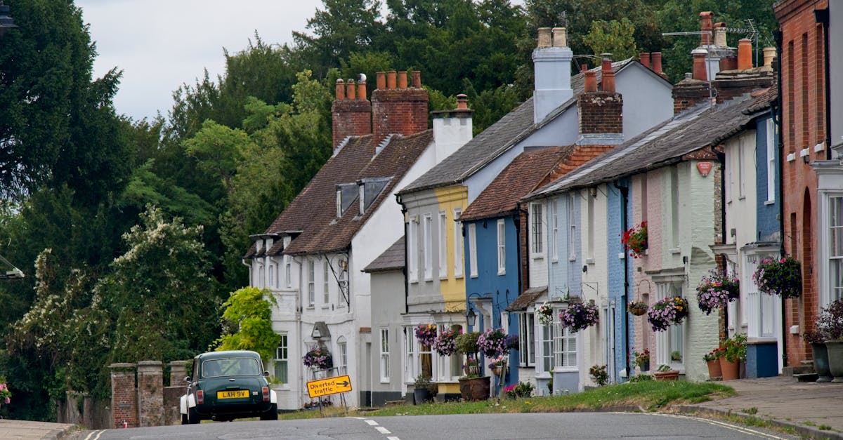 Colorful houses and classic car on a quaint street in New Alresford, England.