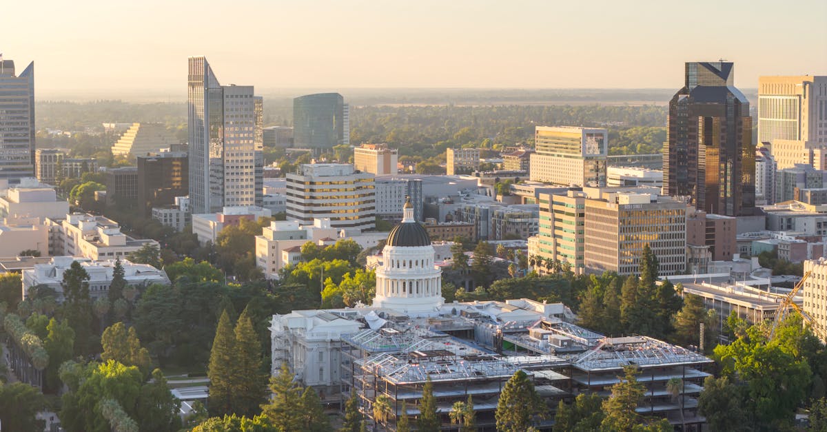 Aerial view of Sacramento cityscape featuring the California State Capitol at sunset.